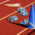 Cheerleader pom poms and megaphone