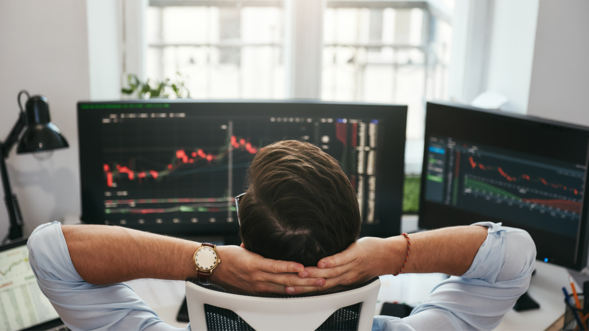 Trader watching stock charts on multiple monitors, illustrating SEC disgorgement authority in securities enforcement.