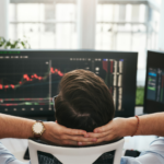 Trader watching stock charts on multiple monitors, illustrating SEC disgorgement authority in securities enforcement.